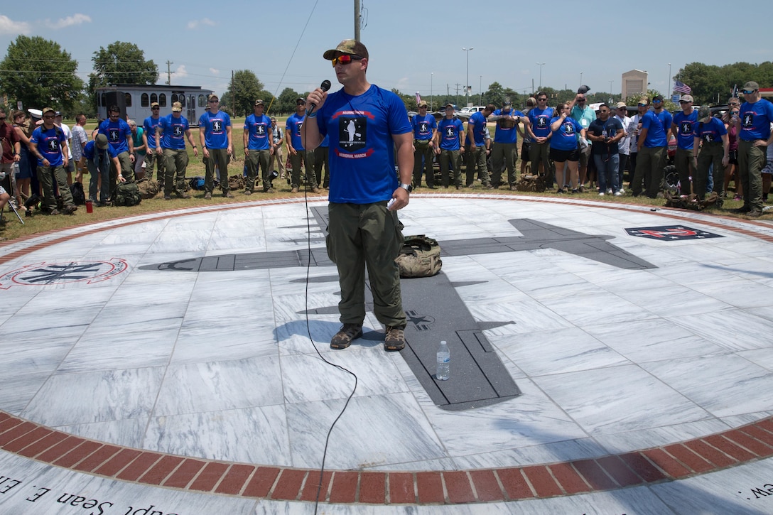 The Rucking Raiders come together at the Memorial Marker, after the dedication ceremony, to say a prayer before beginning the 900 mile ruck march from Greenwood, Miss. To Camp Lejeune, N.C., on July 14, 2018. The group of 30 former comrades and widows of members of Marine 2nd Raider Battalion will have rotating teams that will be on the road around the clock through July 27, carrying dirt from the crash site of the fallen Marines and Sailor, back to the home station of Camp Lejeune, N.C.  (U.S. Marine Corps photo by Lance Cpl. Samantha Schwoch/released)