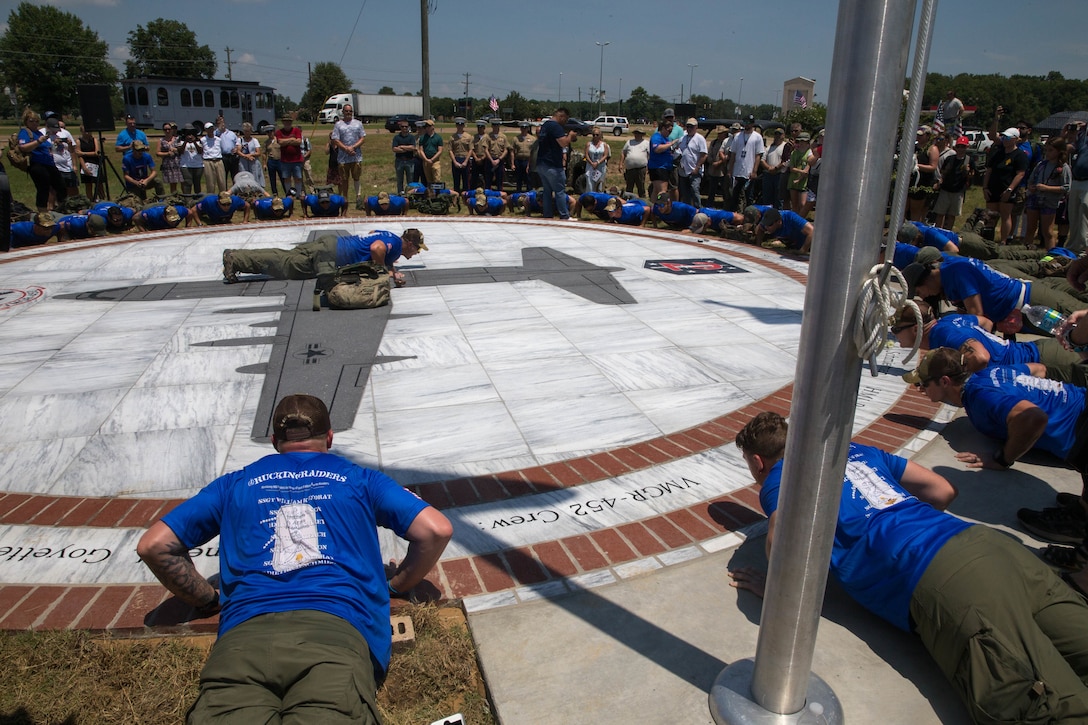 The Marine Raider Memorial March participants do a set of pushups around the Memorial Marker, after the dedication ceremony, to say a prayer before beginning the 900 mile ruck march from Greenwood, Miss. To Camp Lejeune, N.C., on July 14, 2018. The group of 30 former comrades and widows of members of Marine 2nd Raider Battalion will have rotating teams that will be on the road around the clock through July 27, carrying dirt from the crash site of the fallen Marines and Sailor, back to the home station of Camp Lejeune, N.C. (U.S. Marine Corps photo by Lance Cpl. Samantha Schwoch/released)