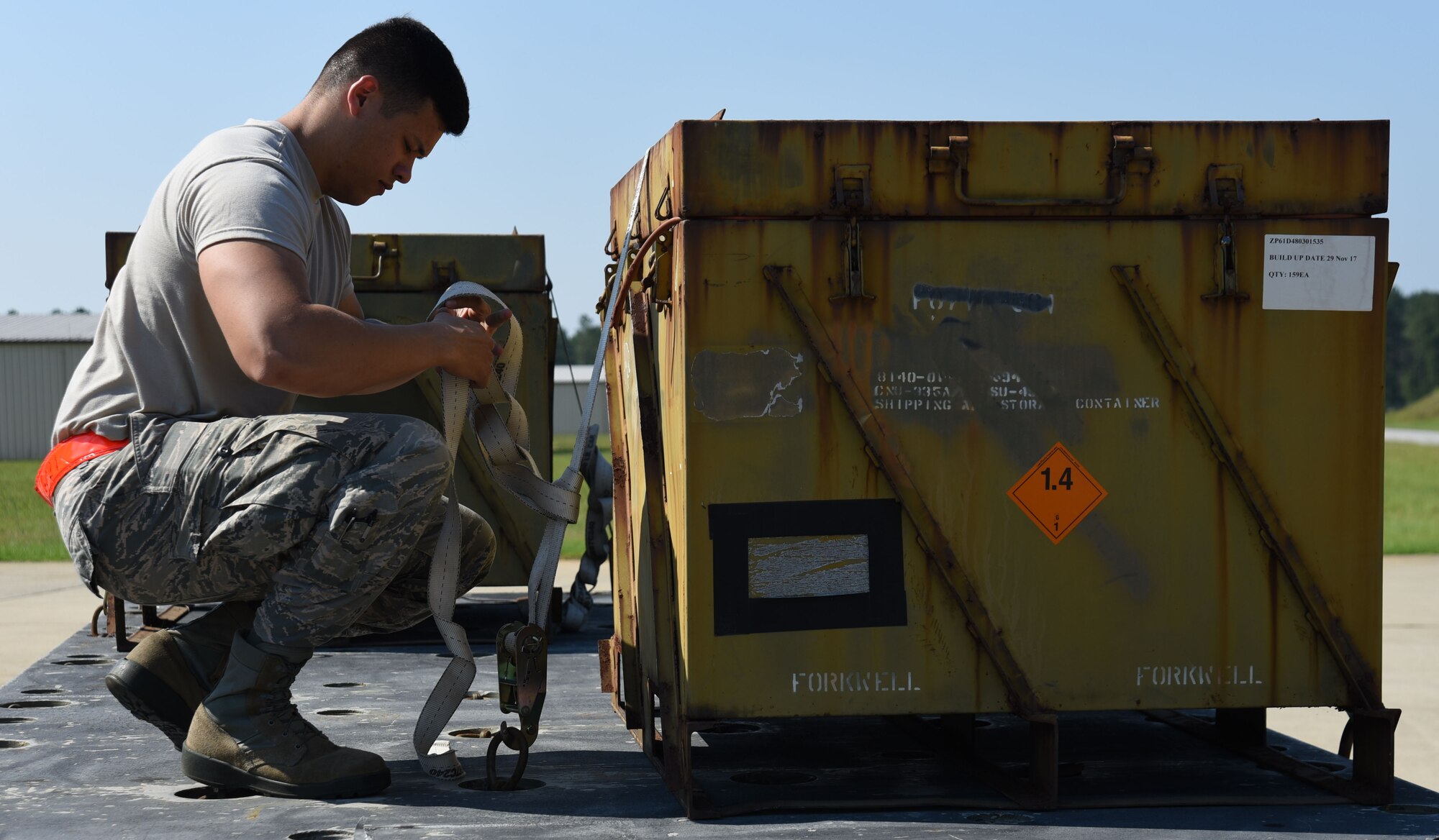 U.S. Air Force Airman 1st Class Cristian Arroyo, 20th Equipment Maintenance Squadron (EMS) conventional maintenance crew member, adjusts straps securing munitions on a trailer at Shaw Air Force Base, S.C., July 10, 2018.