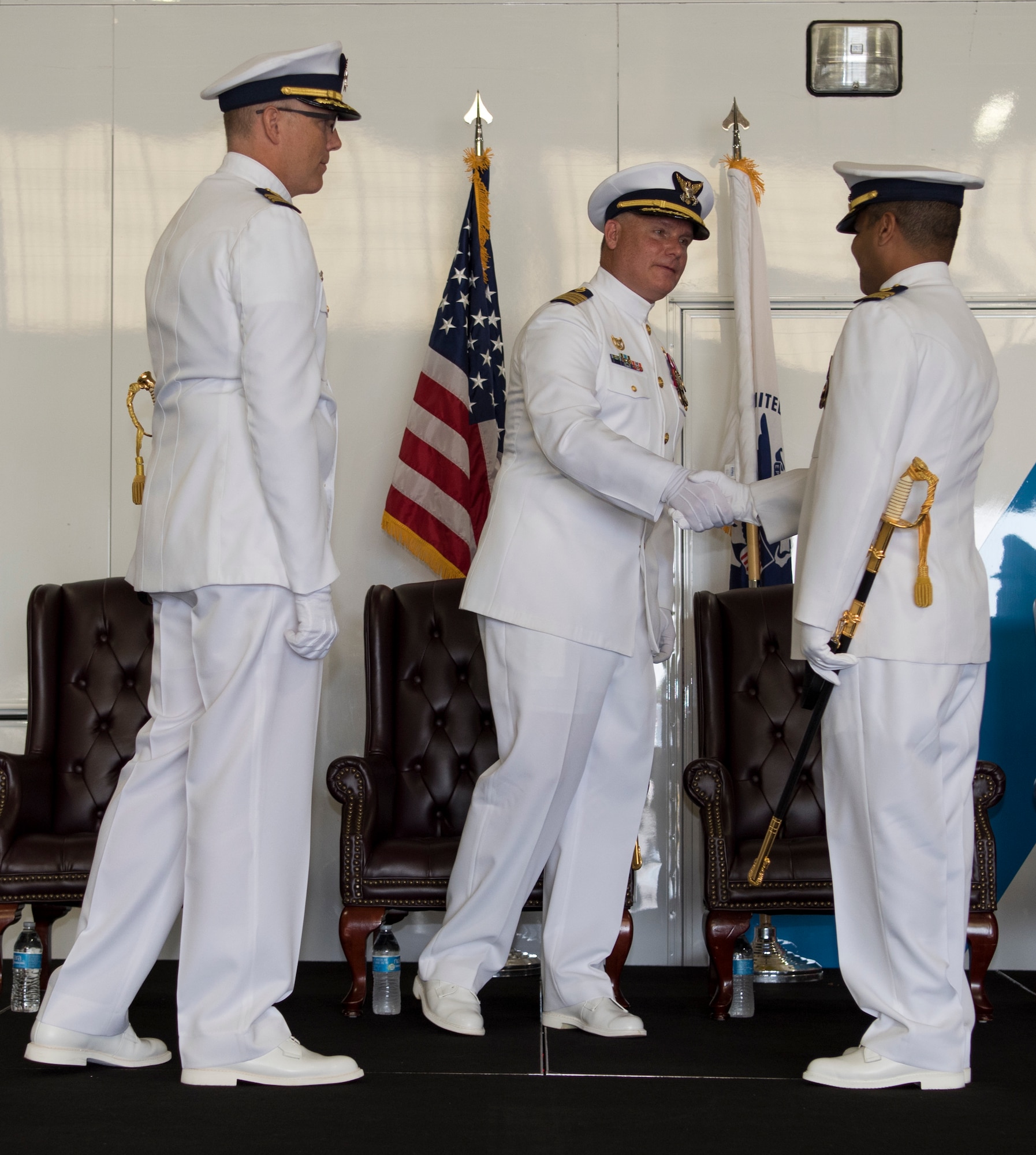 U.S. Coast Guard Capt. Mark Shepard, the presiding official, shakes hands with Cmdr. Raymond Negron, the incoming commanding officer for the U.S. Coast Guard Atlantic Strike Team, during the Atlantic Strike Team change of command ceremony on Joint Base McGuire-Dix-Lakehurst, N.J., July 12, 2018. Negron traveled from the Republic of Liberia where he advised the U.S. ambassador on safety and security issues. (U.S. Air Force photo by Airman Ariel Owings)