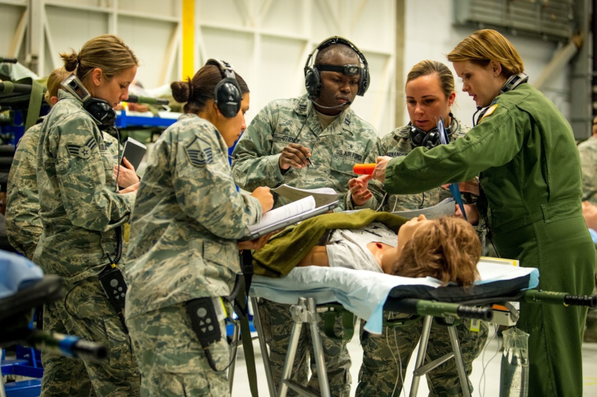 Flight Nurse and Aeromedical Technician Course students discuss patient briefs from actual Aeromedical Evacuation missions with their instructor, Capt. Sarah Johnson, right, before boarding a C-130 mockup to treat simulated patients at the 711th Human Performance Wing's U.S. Air Force School of Aerospace Medicine at Wright Patterson AFB, Ohio, Jan. 29, 2018. (U.S. Air Force photo by J.M. Eddins Jr.)