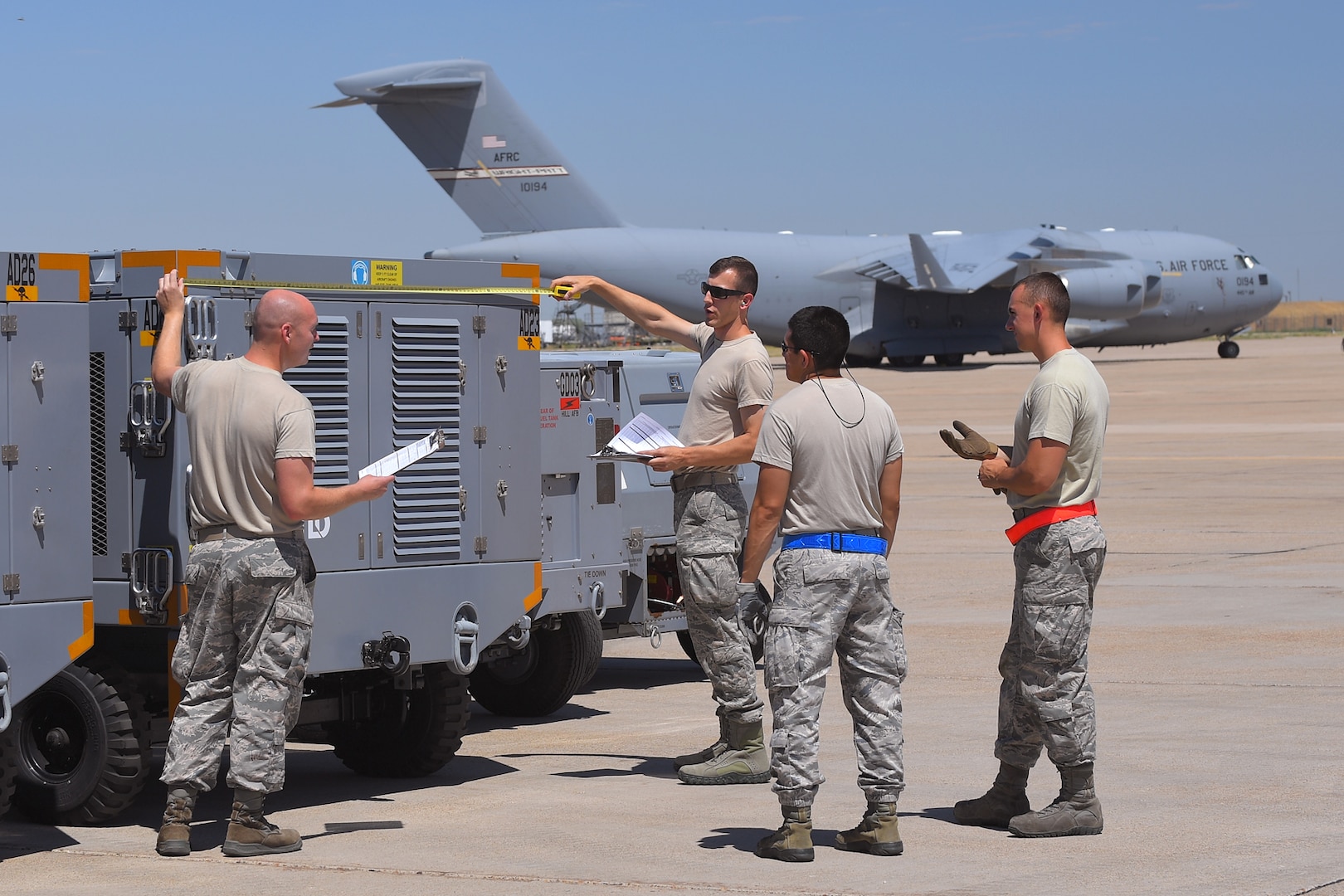 (Left to right) Staff Sgt. Joshua Echols and Tech. Sgt. Zachary Burson, 75th Logistics Readiness Squadron, along with Staff Sgts. Adan Nunez and Justin Murphy, 388th Maintenance Squadron, measure equipment during an exercise July 13, 2018, at Hill Air Force Base Utah. (U.S. Air Force photo by Todd Cromar)