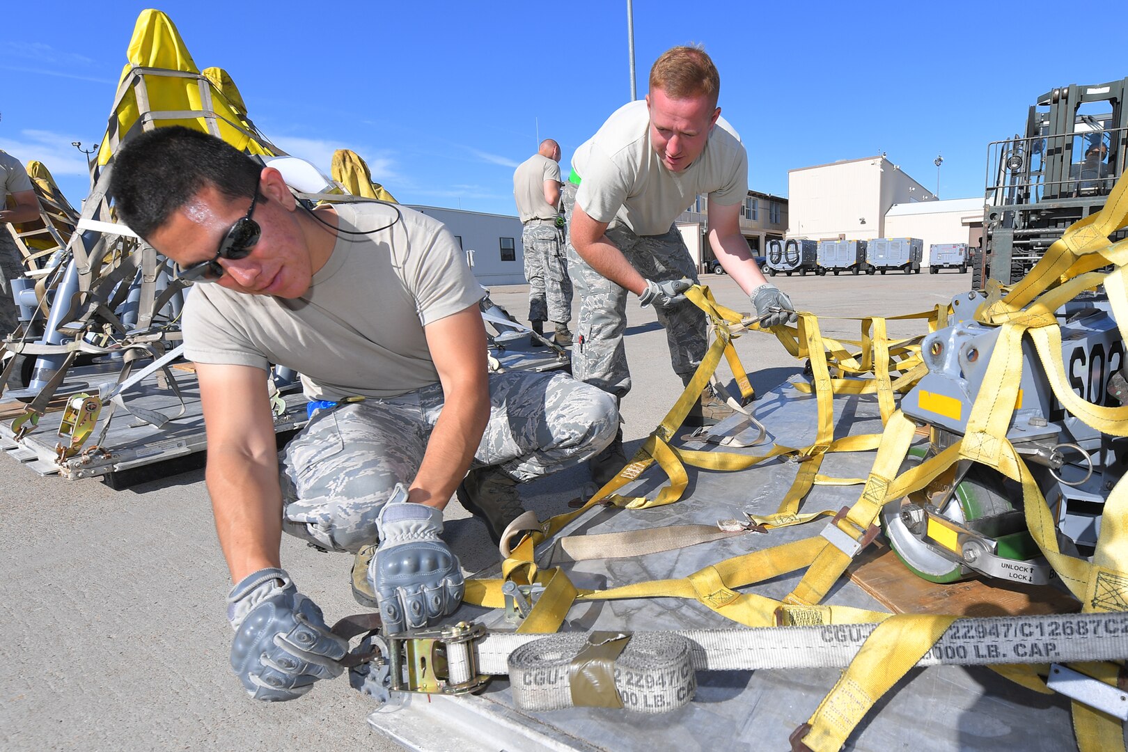 Staff Sgt. Adan Nunez and Airman 1st Class Tyler Russell, 388th Maintenance Squadron, prepare cargo during an exercise July 13, 2018, at Hill Air Force Base Utah. (U.S. Air Force photo by Todd Cromar)