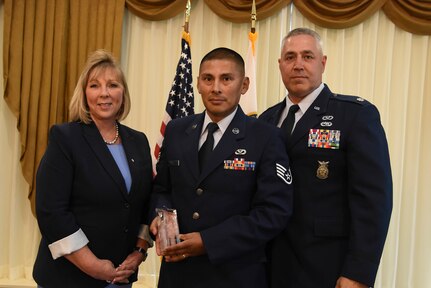 From left to right: Cynthia S. Tolle, the director of acquisitions and head of contracting activities for the National Guard Bureau, Air Force Staff Sgt. Luis Juro, an engineering assistant and contracting officer representative with the Connecticut Air National Guard's 103rd Airlift Wing, and Air Force Lt. Col. Henry Chmielinski, a squadron commander with the 103rd Airlift Wing, pose for a photograph during the Excellence in Contracting Awards Program at Fort Belvoir, Virginia, July 12, 2018. Juro won in the Excellence in Contract Administration category and was one of ten winners at the ceremony that recognized the achievements and contributions of contracting specialists throughout the National Guard.