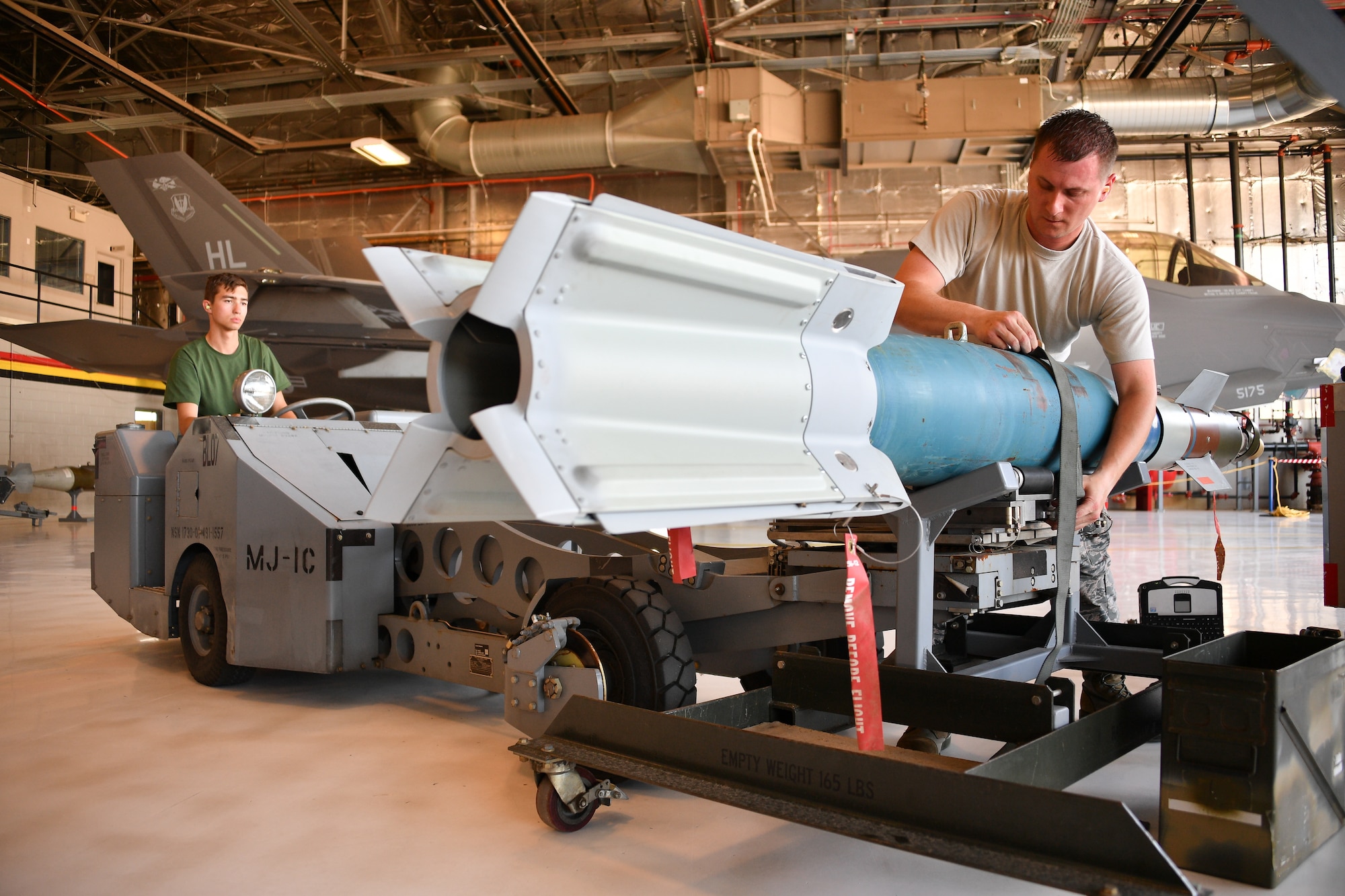 Staff Sgt. Andrew Rapp (right) and Senior Airman Connor Hansen, 419th Aircraft Maintenance Squadron, prepare to load a weapon onto an F-35 Lightning II during a friendly competition July 6 at Hill Air Force Base, Utah