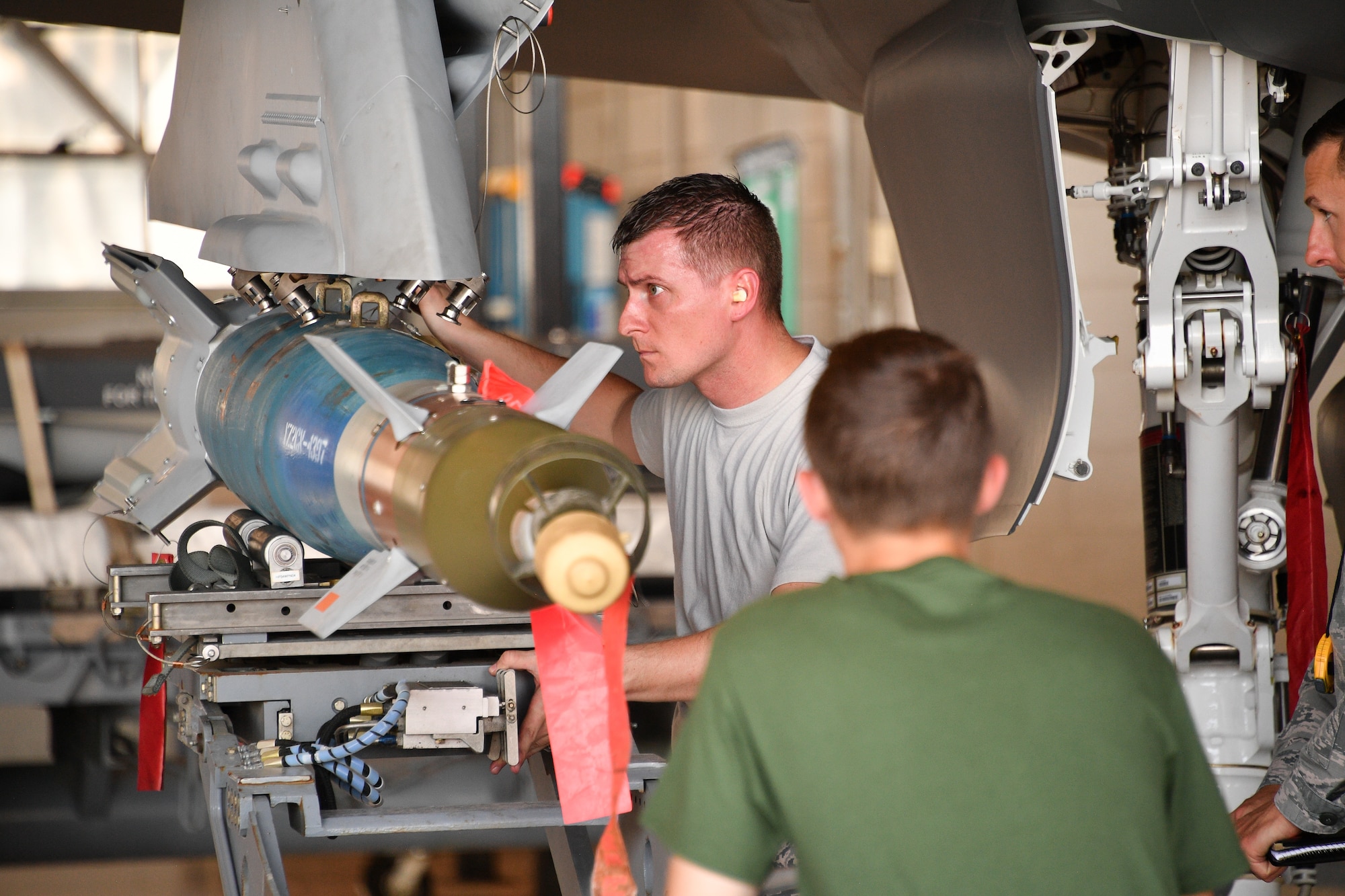 Staff Sgt. Andrew Rapp, 419th Aircraft Maintenance Squadron, loads a bomb onto the wing of an F-35 Lightning II during a friendly competition July 6 at Hill Air Force Base, Utah.