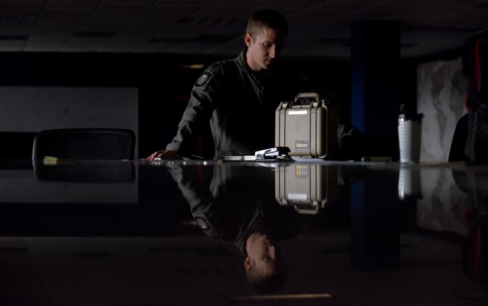 U.S. Air Force Capt. Brad Polender, 15th Airlift Squadron flight commander, gives a safety brief to his aircrew in the mission planning room of the 15 AS before departing July 12, 2018, to Westover Air Reserve Base, Mass., for the Great New England Air Show.