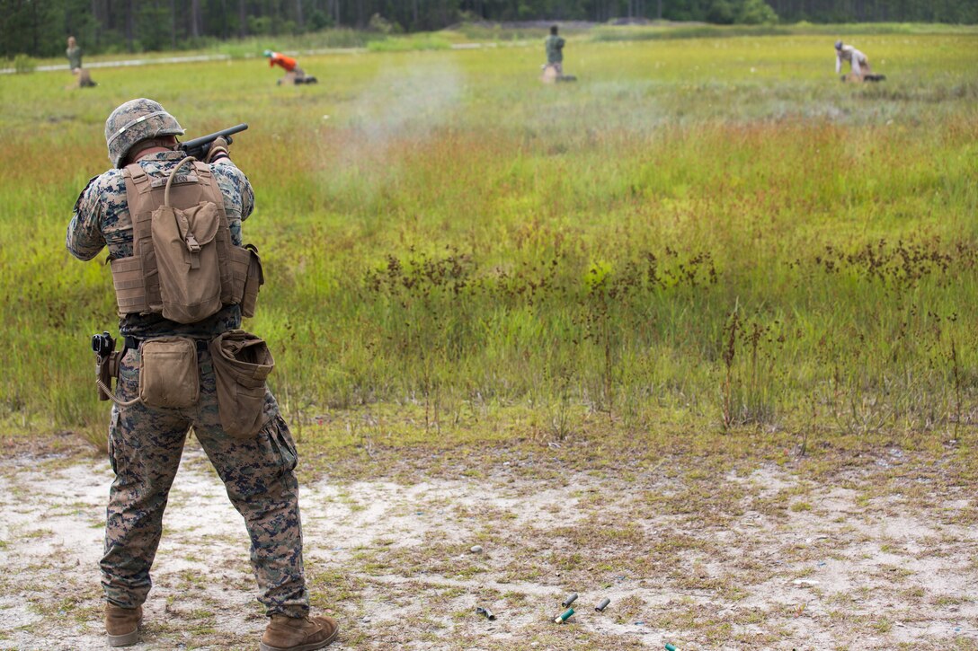 U.S. Marine Corps Lance Cpl. Levi Burton with 2nd Law Enforcement Battalion, II Marine Expeditionary Force Information Group fires a 12-gauge shotgun during a live-fire range, testing a new autonomous robotic target system at Camp Lejeune, N.C., June 26, 2018. The Marines used the targets to further develop their marksmanship skills, anticipate natural movement and increase combat effectiveness. (U.S. Marine Corps photo by Lance Cpl. Tanner Seims)