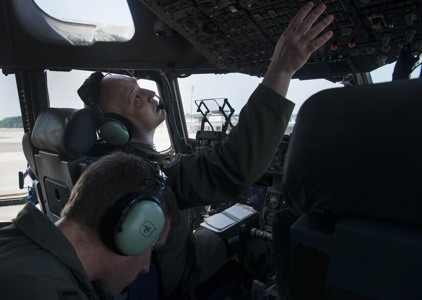 U.S. Air Force Lt. Col. J.D. Fariss, 437th Operations Group wing chief of standardization and evaluation, checks the upper panel of controls during a pre-flight checklist before taking off from Joint Base Charleston, S.C.