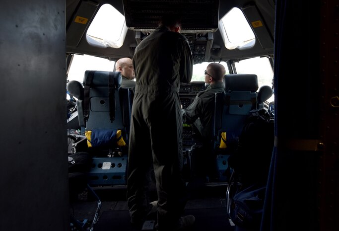 U.S. Air Force Lt. Col. J.D. Fariss, 437th Operations Group wing chief of standardization and evaluation, left, U.S. Air Force Capt. Brad Polender, 15th Airlift Squadron flight commander, center and German air force Major Rico Persy, 14th Airlift Squadron German exchange pilot, right, prepare for a performance during the Great New England Air Show in Westover, Mass.