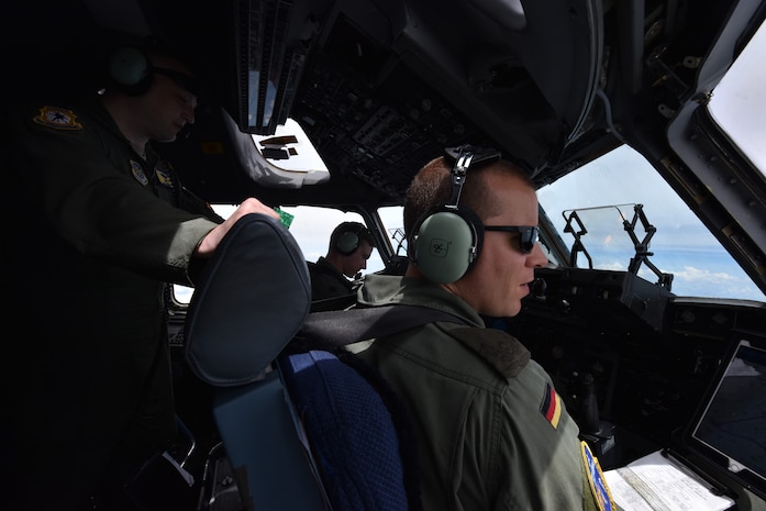 U.S. Air Force Capt. Brad Polender, 15th Airlift Squadron flight commander, center, U.S. Air Force Lt. Col. J.D. Fariss, 437th Operations Group wing chief of standardization and evaluation, left, and German air force Major Rico Persy, 14th Airlift Squadron German exchange pilot, right, prepare for a performance during the Great New England Air Show in Westover, Mass.