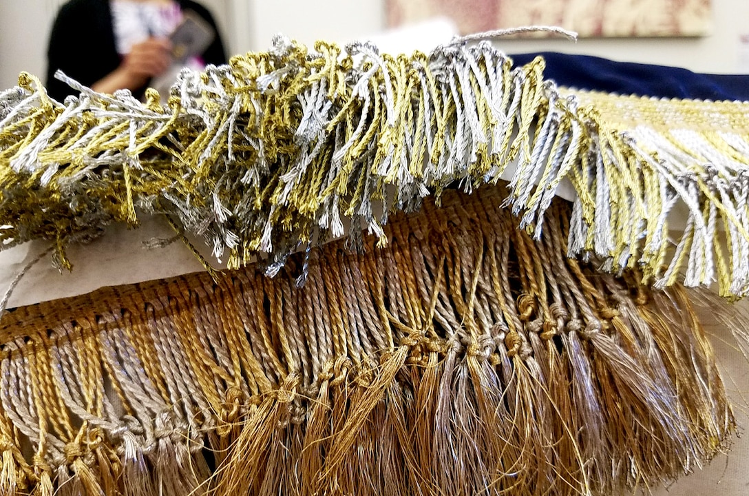 The current 50-star presidential flag, top, and the only 49-star presidential flag ever made are compared during a visit to DLA Troop Support Clothing and Textiles’ Flag Room by presidential flag collectors in late June in Philadelphia. The fringes of the 49-star flag are made with real gold and silver while today’s presidential flags have metallic threads.