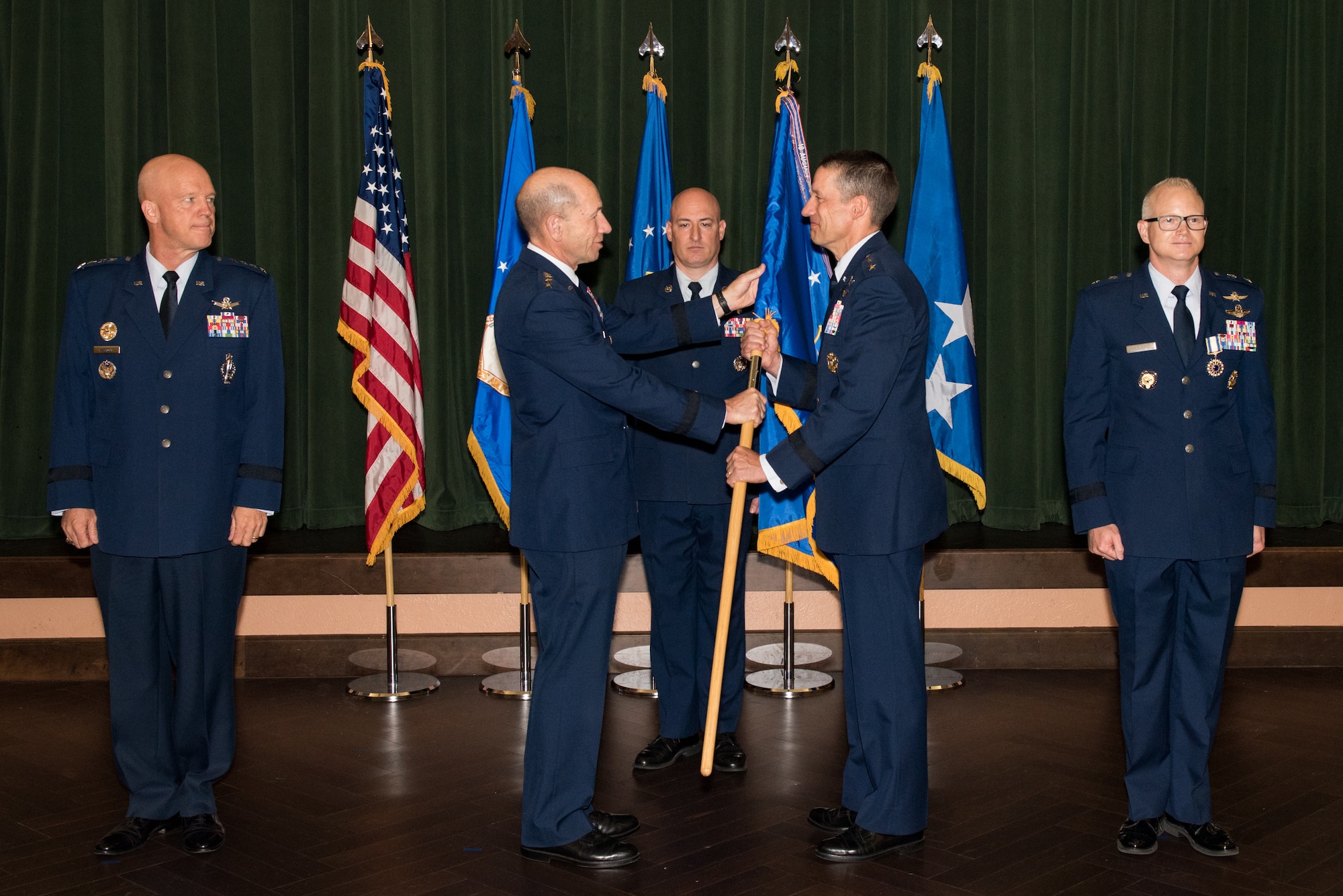 Gen. Mike Holmes, commander of Air Combat Command, presents the 24th Air Force guidon to Maj. Gen. Robert Skinner upon assuming command of the 24th AF during a ceremony at Joint Base San Antonio-Lackland, Texas, July 17, 2018. Twenty Fourth Air Force was reassigned to a new major command and welcomed Skinner during the ceremony. (U.S. Air Force photo by Andrew C. Patterson)
