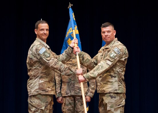 Col. Ian Chase (left), 920th Rescue Wing vice commander, passes the 920th Mission Support Group’s flag to Lt. Col. Adolph Rodriguez, symbolizing the passing of responsibility during an assumption of command, July 14, 2018, at Patrick Air Force Base, Florida. (U.S. Air Force photo by Staff Sgt. Jared Trimarchi)