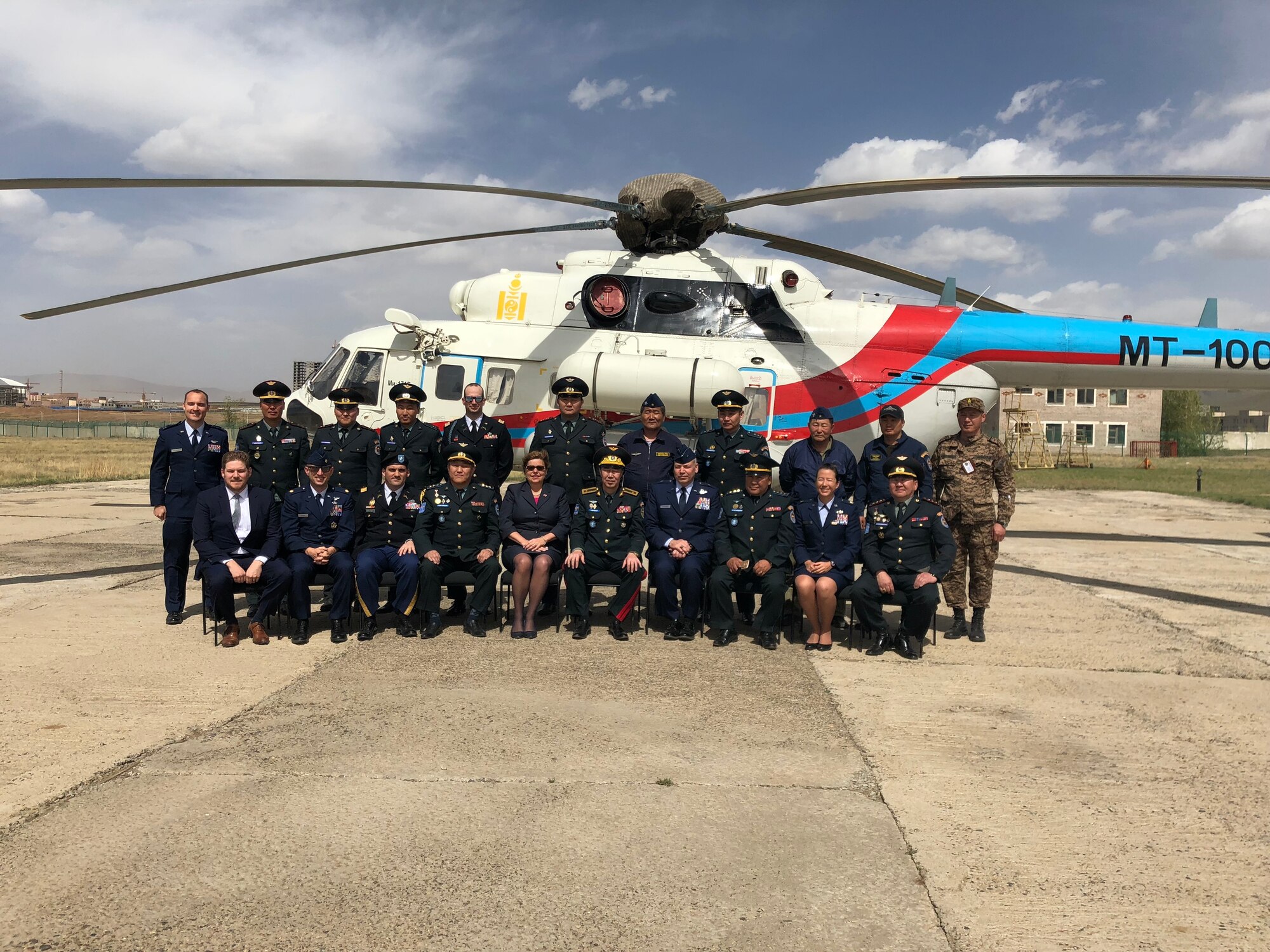 The United States Air Force delegation and Mongolian air force members pose for a photo in front of a Mongolian helicopter in Ulaanbaatar, Mongolia, May 18, 2018.