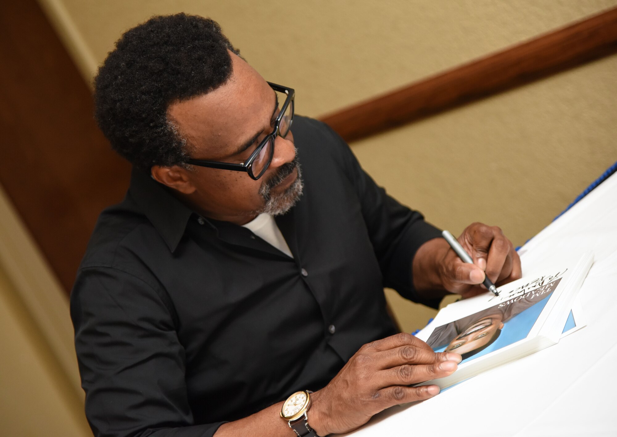 Tim Meadows, actor and comedian, signs autographs for Keesler personnel following a performance at the Bay Breeze Event Center at Keesler Air Force Base, Mississippi, July 14, 2018. Meadows is also an alumni of the late-night comedy show, Saturday Night Live. (U.S. Air Force photo by Kemberly Groue)
