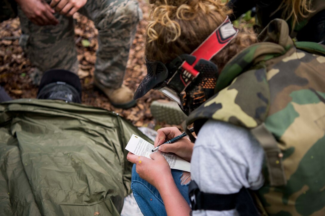 U.S. Air Force 2nd Lt. Shelby Landfair, registered nurse assigned to the 673d Inpatient Operations Squadron, fills out a DD form 1380, Tactical Combat Casualty Care medical card, during the practical application of the TCCC course at the Warrior Extreme Paintball course at Joint Base Elmendorf-Richardson, Alaska, July 13, 2018. The course is an opportunity for every student to provide care under fire, perform tactical field care on those who are injured and execute a tactical evacuation.
