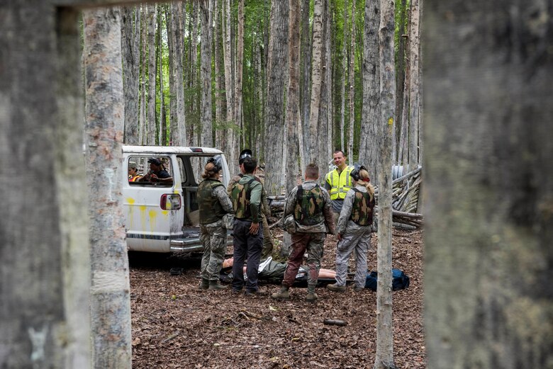A Tactical Combat Casualty Care instructor and 673d Medical Group personnel discuss their performance during the practical application of the TCCC course at the Warrior Extreme Paintball course at Joint Base Elmendorf-Richardson, Alaska, July 13, 2018. The course is an opportunity for every student to provide care under fire, perform tactical field care on those who are injured and execute a tactical evacuation.