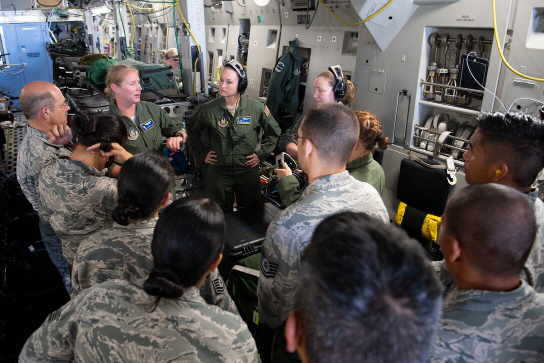 U.S. Air Force Master Sgt. Michelle Geers, an aeromedical evacuation technician from the 315th Aeromedical Evacuation Squadron, discusses various types of life-saving equipment used aboard a U.S. Air Force C-17 Globemaster III aircraft with 624th Aeromedical Staging Squadron personnel at U.S. Coast Guard Air Station Barbers Point, Hawaii, July 10, 2018, during Pacific Lifeline 2018.