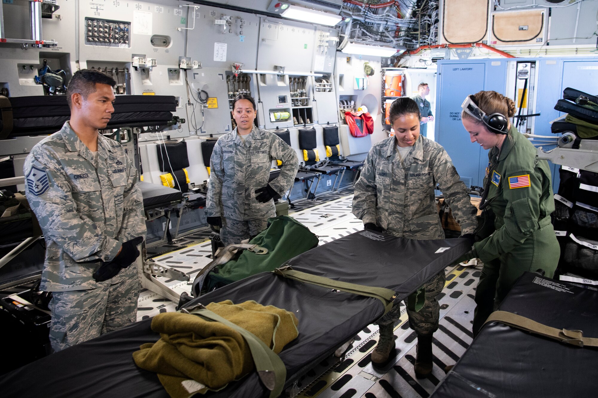 U.S. Air Force Staff Sgt. Jodi Signer, an instructor from the 446th Aeromedical Evacuation Squadron, familiarizes 624th Aeromedical Staging Squadron personnel with patient equipment aboard a U.S. Air Force C-17 Globemaster III aircraft at U.S. Coast Guard Air Station Barbers Point, Hawaii, July 10, 2018, during Pacific Lifeline 2018.