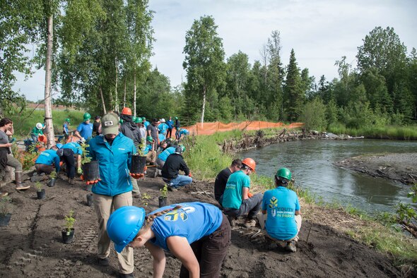 The Pacific Air Forces’ F-16 Demonstration Team plants native vegetation by a riverbank with the Youth Employment in Parks program members in Anchorage, Alaska, June 29, 2018. The YEP program provides a 10-week summer program, hiring Anchorage teens to complete park improvement projects. Participants learn natural resource management job skills by building trails and restoring stream banks. (U.S. Air Force photo by Senior Airman Sadie Colbert)