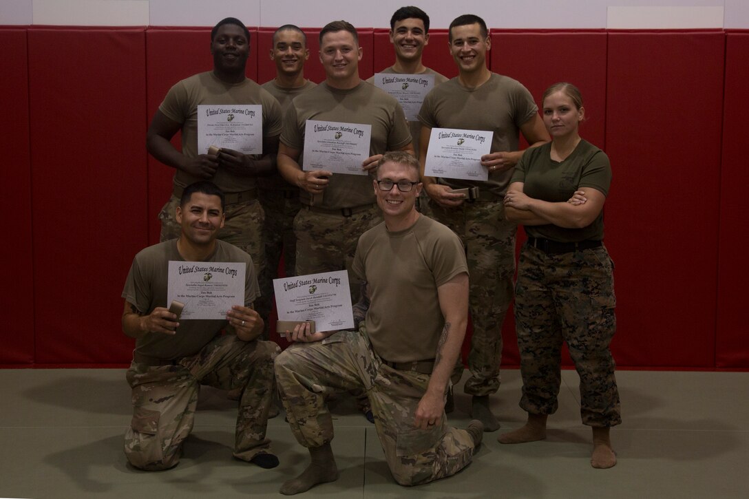 CAMP FOSTER, OKINAWA, Japan – Soldiers pose with their Marine instructor after earning their tan belts and certificates during Marine Corps Martial Arts Program training June 28 at Gunner’s Gym aboard Camp Foster, Okinawa, Japan.