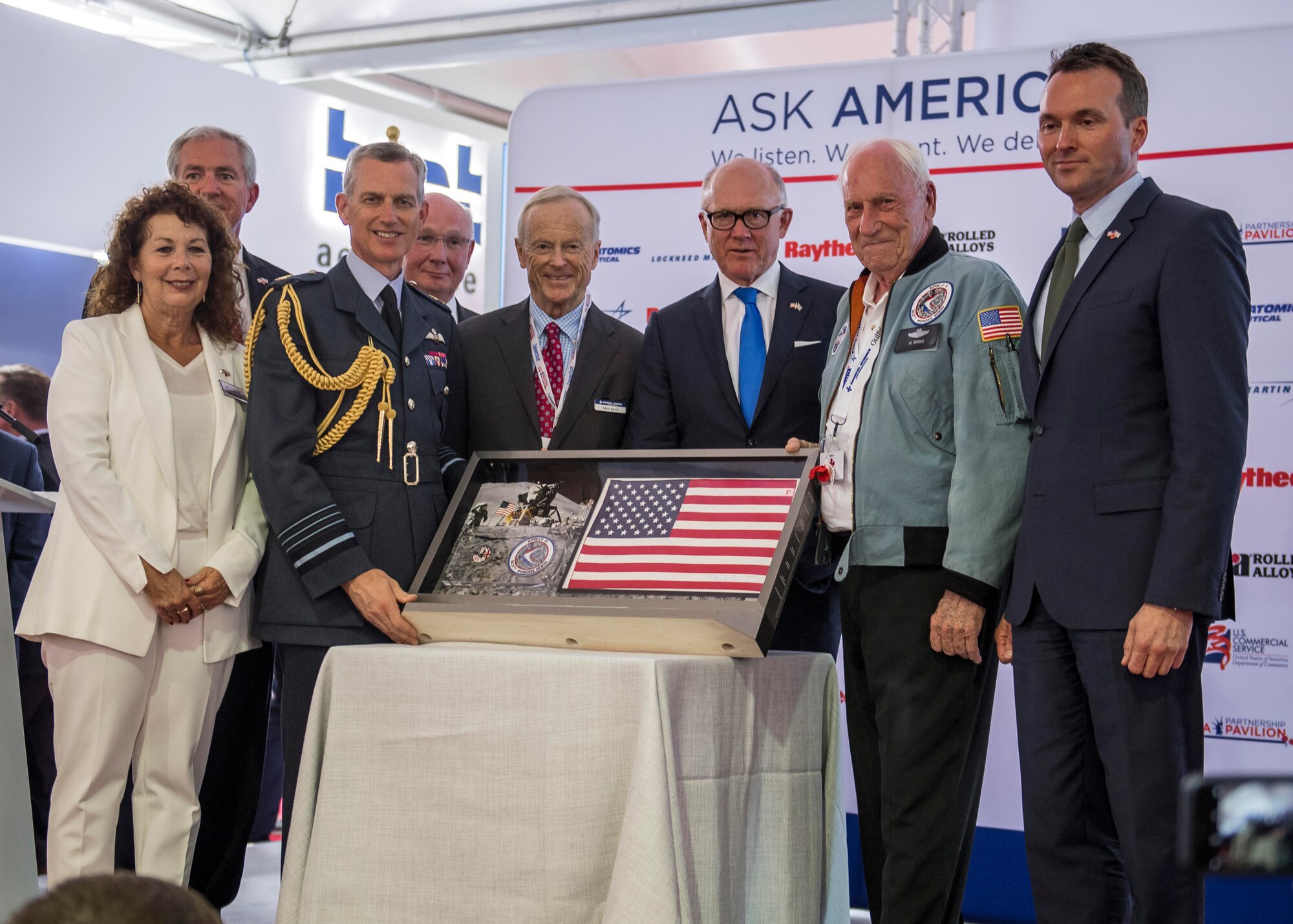 U.S. and U.K. guests of honor pose for a photo following the opening ceremony of the Farnborough International Airshow July 16, 2018. The ceremony featured an Apollo 15 flag presentation to the Royal Air Force Chief of Staff, Air Chief Marshal Sir Stephen Hillier, to commemorate their RAF centennial celebration. U.S. guests of honor included: the Honorable Robert Wood Johnson, U.S. Ambassador to the U.K., 22nd Secretary of the Army Eric Fanning, and Retired Col. Al Woden, Command Module Pilot for the Apollo 15 lunar mission in 1971. (U.S. Navy photo by MC2 Cody Hendrix)