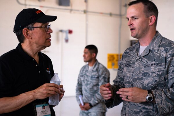 A civilian speaks with a service member.