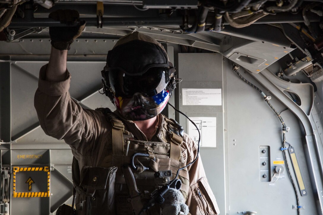 A U.S. Marine Corps MV-22B Osprey crew chief prepares for take-off at Al Asad Air Base, Iraq, June 6, 2018. CJTF-OIR is the military arm of the Global Coalition to defeat ISIS in designated parts of Iraq and Syria.