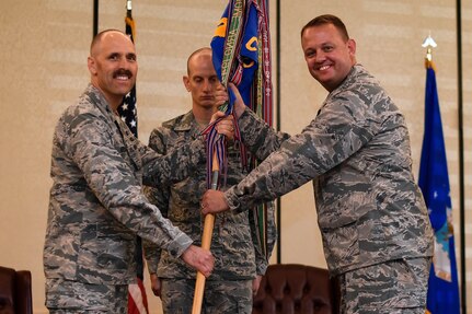 Lt. Col. Tony M. Wickman receives the 1st Combat Camera Squadron guidon from Col. Todd Vician, Air Force Public Affairs Agency commander, during the change of command ceremony July 17, 2018, at Joint Base Charleston, S.C.
