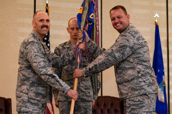 Lt. Col. Tony M. Wickman receives the 1st Combat Camera Squadron guidon from Col. Todd Vician, Air Force Public Affairs Agency commander, during the change of command ceremony July 17, 2018, at Joint Base Charleston, S.C.