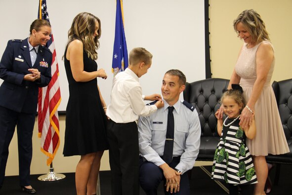 Connor Cruz, U.S. Air Force Staff Sgt. Brandon Cruz’s son, pins first lieutenant bars on his dad’s uniform at MacDill Air Force Base, Fla., June 12, 2018.
