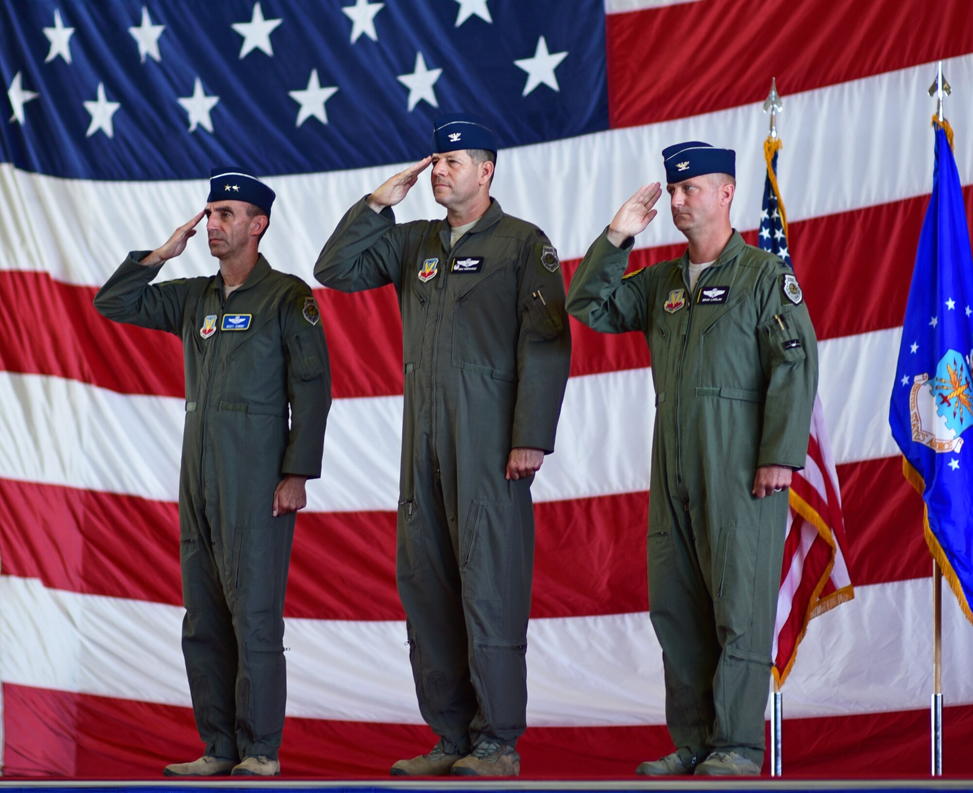 Commanders salute during wing change of command ceremony.