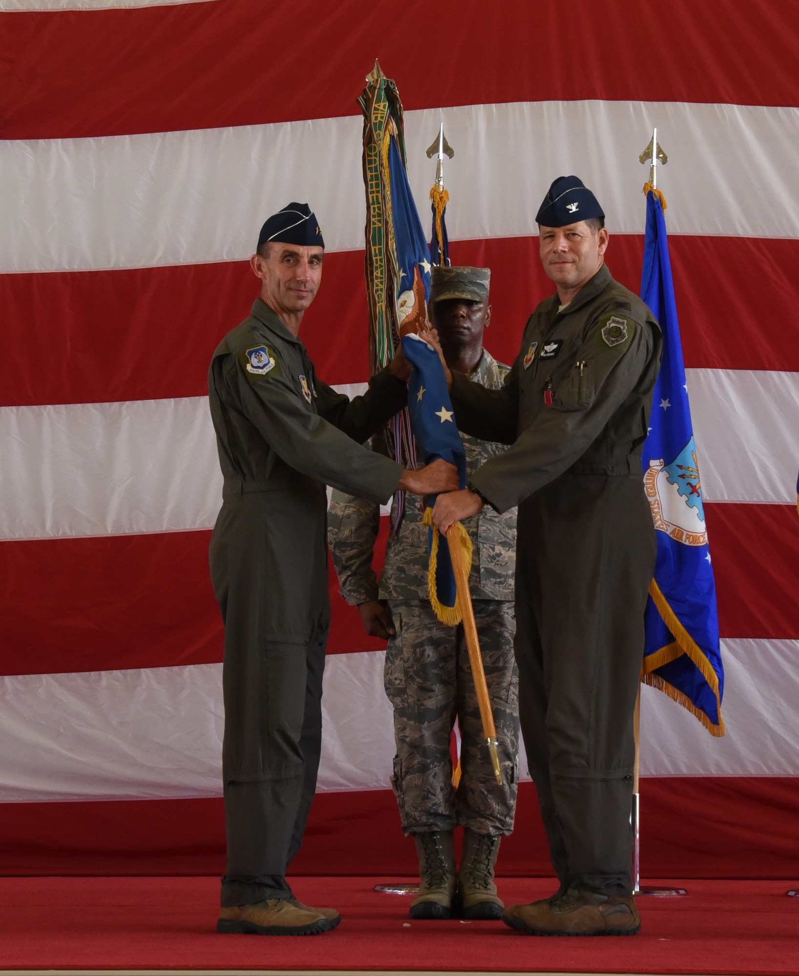 Col. Michael Hernandez relinquishes his command by passing the guidon to Maj. Gen. Scott J. Zobrist.