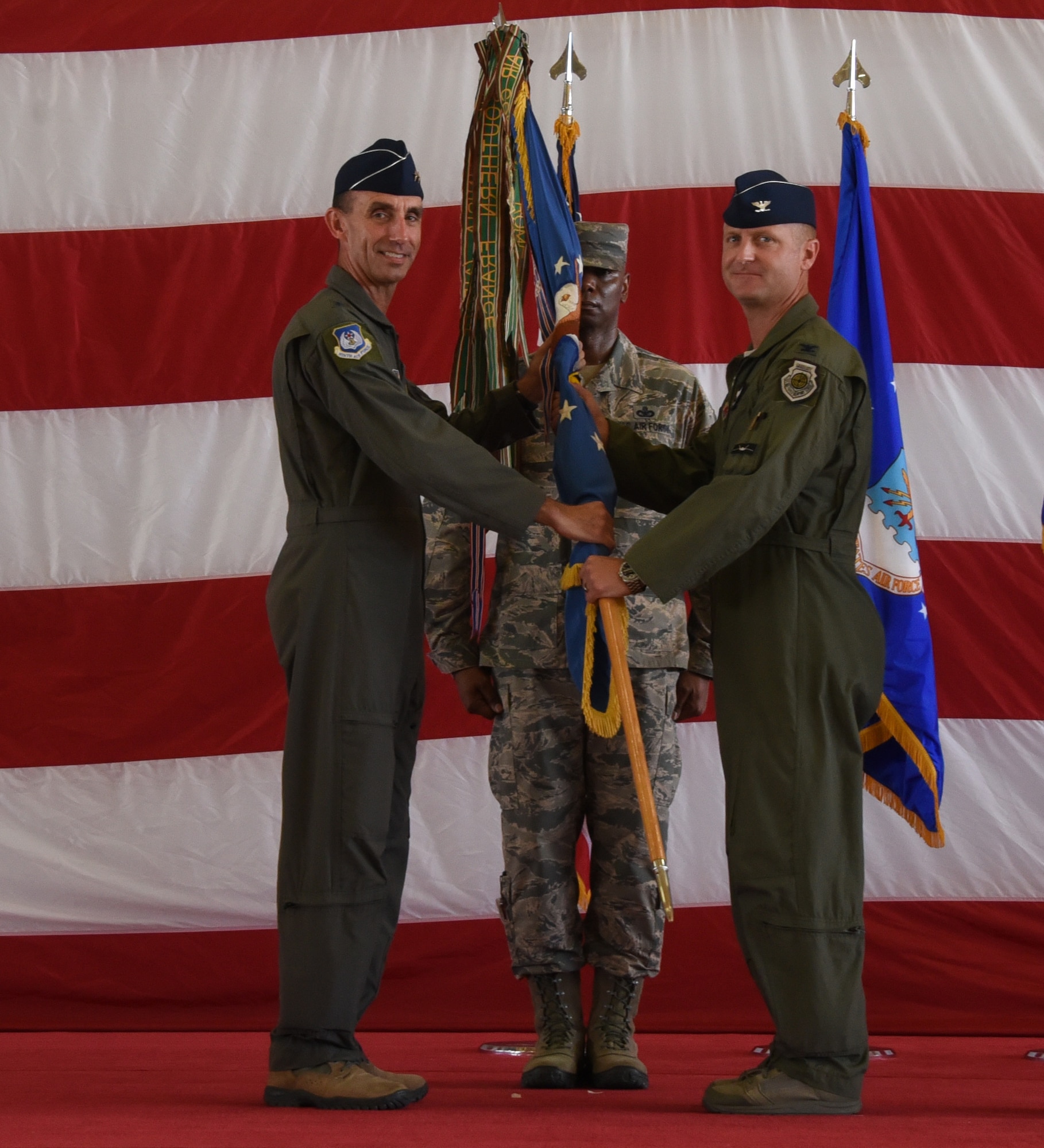 Col. Brian Laidlaw accepts the wing guidon from Maj. Gen. Scott J. Zobrist during the wing change of command ceremony.