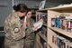 Airman 1st Class Esther Oswald (left), 332 Expeditionary Commination Squadron network technician, and Senior Airman Celeste Cerney, 332nd Expeditionary Force Support Squadron learning resource center, review books at the LRC at an undisclosed location July 17, 2018.