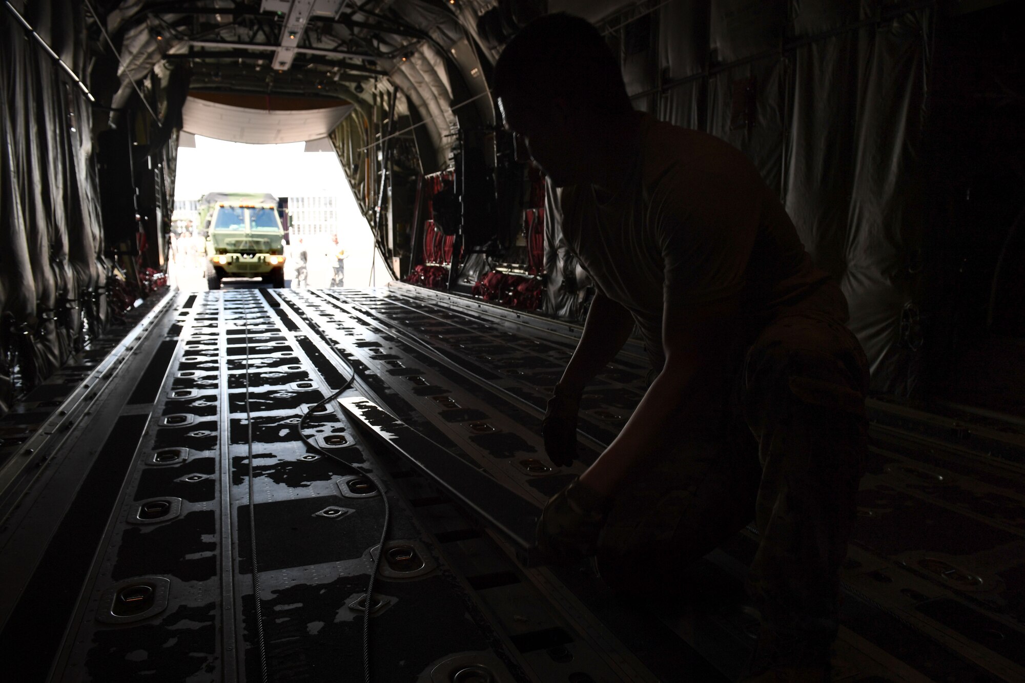 Airman flips panel of plane.