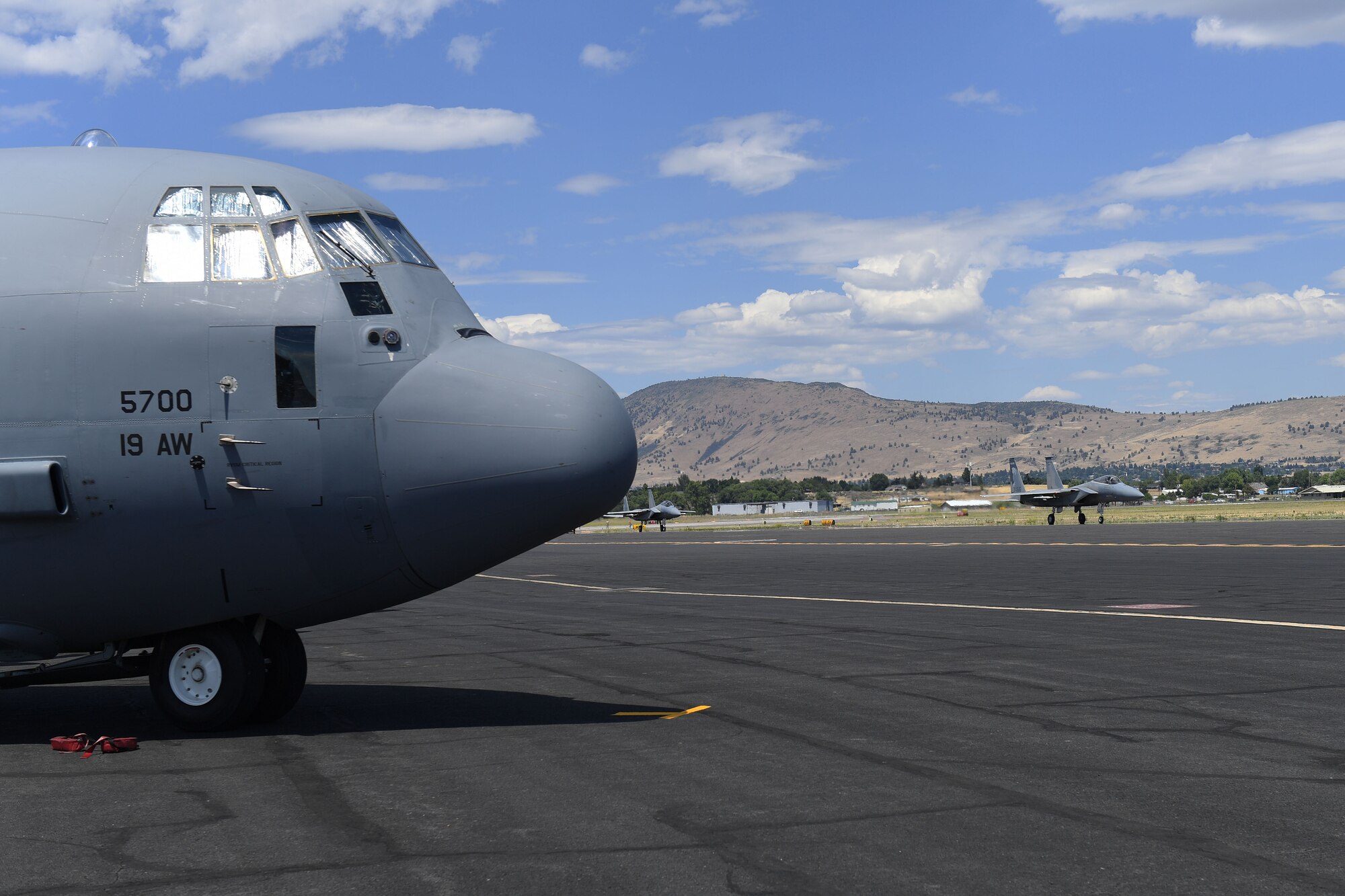 Two planes go by a stationary plane.