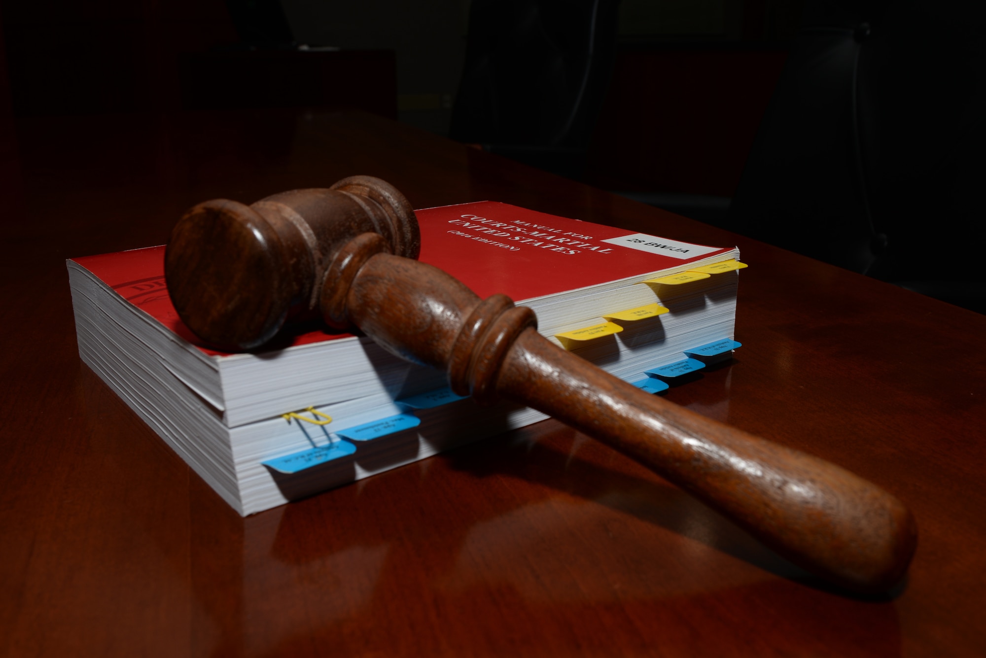 A gavel lays on the Uniform Code of Military Justice inside the 28th Bomb Wing courtroom at Ellsworth Air Force Base, S.D., July 17, 2018. The UCMJ is the primary legal code that governs all internal military justice matters. (U.S. Air Force photo by Airman 1st Class Nicolas Z. Erwin)