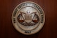 The seal of the Judge Advocate General Corps is displayed inside the 28th Bomb Wing courtroom at Ellsworth Air Force Base, S.D., July 17, 2018. The Ellsworth Judge Advocate office serves as the legal advisor for the 28th Bomb Wing. They handle issues including administrative law, government contracting and military law. (U.S. Air Force photo by Airman 1st Class Nicolas Z. Erwin)