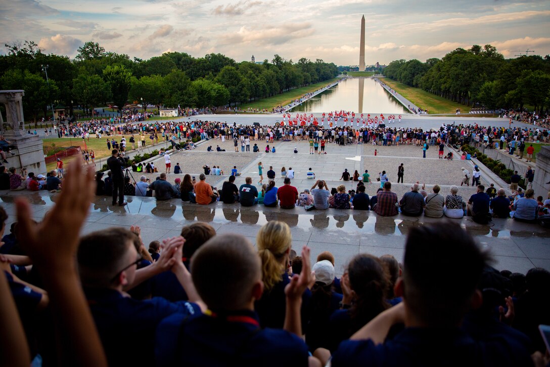 Students with the Summer Leadership and Character Development Academy applaud during The Commandant’s Own Drum and Bugle Corps’ performance at the Lincoln Memorial in the District of Columbia, July 17, 2018. Students accepted into the academy were hand-selected by a board of Marines who look to find attendees with similar character traits as Marines. Inspired by the Marine Corps' third promise of developing quality citizens, the program was designed to challenge and develop the nation's top-performing high school students so they could return to their communities more confident, selfless and better equipped to improve the lives of those around them. (U.S. Marine Corps photo by Staff Sgt. John A. Martinez Jr.)