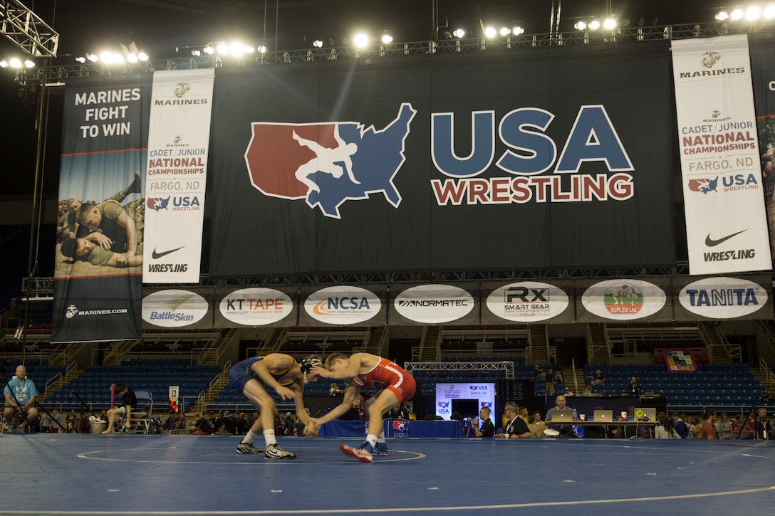 Keegan Slyter, a wrestler from Olathe North High School in Olathe, Kansas, and Khyler Brewer, a wrestler from Kansas City, Missouri, start their match against each other during the 2018 U.S. Marine Corps Freestyle Finals in Fargo, North Dakota, July 15. The Freestyle Finals feature more than 30 top-level athletes from across the country. By partnering with USA Wrestling, the national governing body for the sport in America, the Marine Corps will reach a broad cross-section of high school and collegiate-aged club wrestlers as well as an ever-growing influencer network of coaches, referees, wrestling alumni and parents. (U.S. Marine Corps photo by Lance Cpl. Mitchell Collyer)