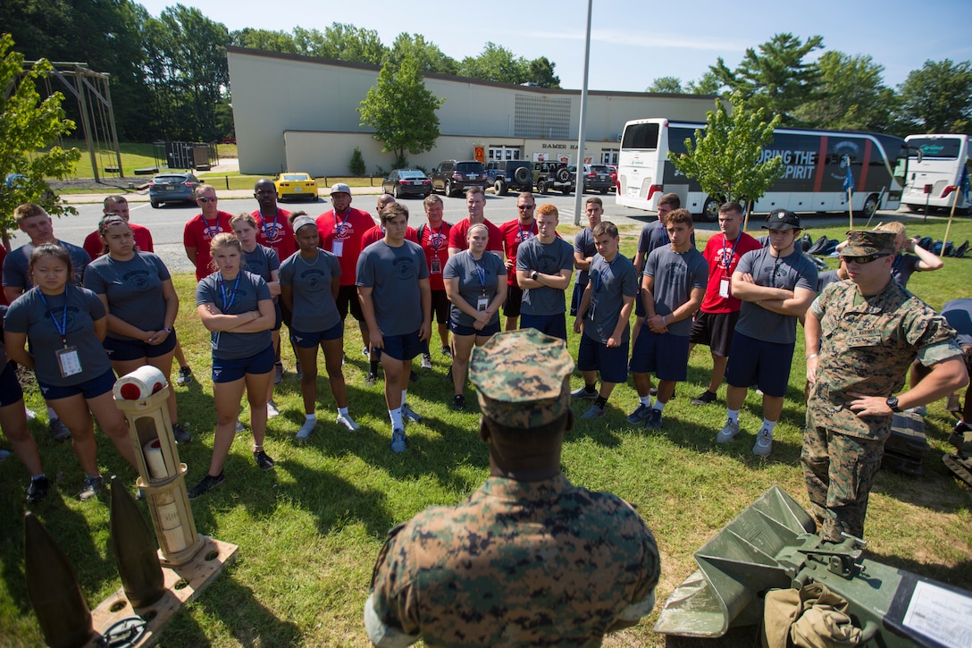Students and mentors gather around the static weapons display during the 2018 Battles Won Academy aboard Marine Corps Base Quantico, Virginia, July 13. The Battles Won Academy is a part of the Marine Corps’ Semper Fidelis All-American Program, which recognizes young men and women who excel in athletics, but have also shown themselves to be leaders in the classroom and in their hometowns. Nearly 100 high school student-athletes attended the academy, which focused on developing their self-confidence, discipline, teamwork, and honing the fighting spirit that embodies the Marine Corps. (U.S. Marine Corps photo by Lance Cpl. Phuchung Nguyen)