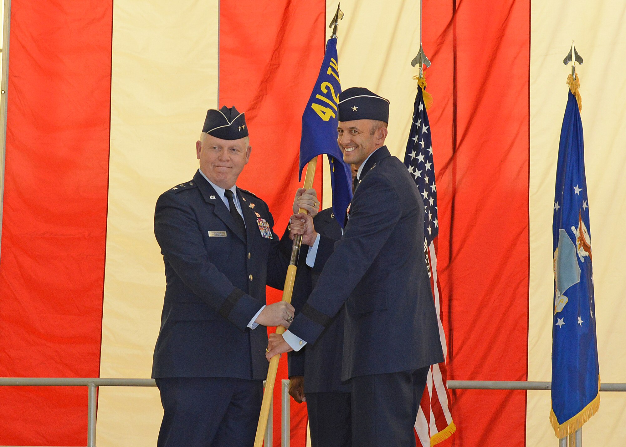 Brig. Gen. E. John Teichert III, gives his first salute to his workforce after assuming command of the 412th Test Wing July 18 in Hangar 1600 at Edwards Air Force Base. (U.S. Air Force photo by Kenji Thuloweit)