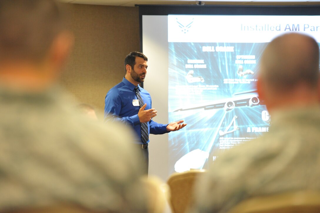 Adam Ryba, representing the Air Force Rapid Sustainment Office, briefs an audience on the use of parts created through additive manufacturing (3-D printing) for Air Force aircraft.