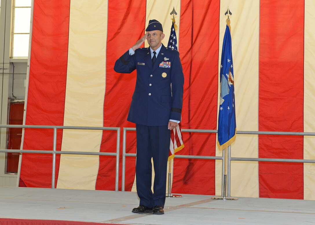 Brig. Gen. E. John Teichert III, gives his first salute to his workforce after assuming command of the 412th Test Wing July 18 in Hangar 1600 at Edwards Air Force Base. (U.S. Air Force photo by Kenji Thuloweit)
