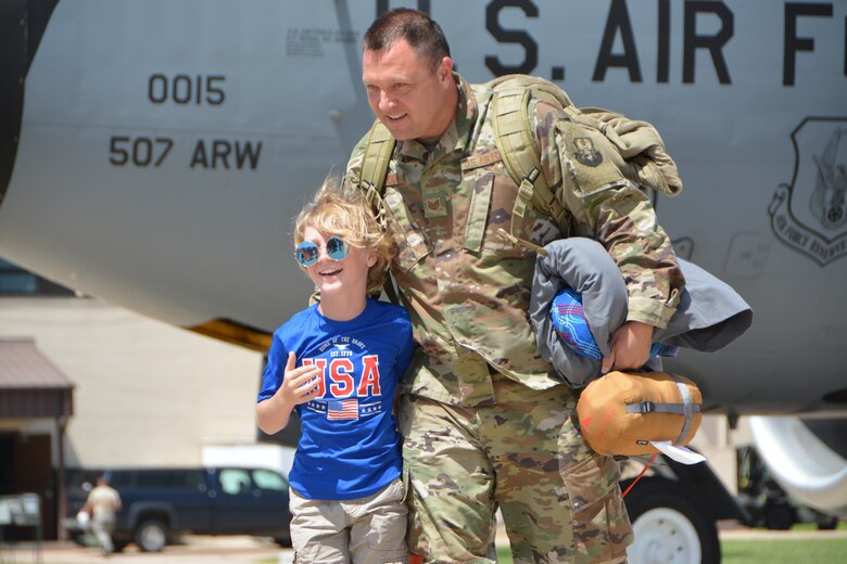 U.S. Air Force Tech. Sgt. Brian Jackson with the 507th Operations Support Squadron at Tinker Air Force Base, Okla., reunites with his son following a deployment July 3, 2018. More than 100 Reserve Citizen Airmen from the 507th Air Refueling Wing at Tinker AFB deployed to Incirlik Air Base, Turkey, in support of air operations. (U.S. Air Force photo by Tech. Sgt. Samantha Mathison)
