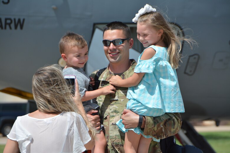 Master Sgt. Vincent Peralta, a KC-135R Stratotanker aircraft crew chief with the 507th Aircraft Maintenance Squadron at Tinker Air Force Base, Okla., reunites with his family following a deployment July 3, 2018. More than 100 Reserve Citizen Airmen from the 507th Air Refueling Wing at Tinker AFB deployed to Incirlik Air Base, Turkey, in support of air operations. (U.S. Air Force photo by Tech. Sgt. Samantha Mathison)