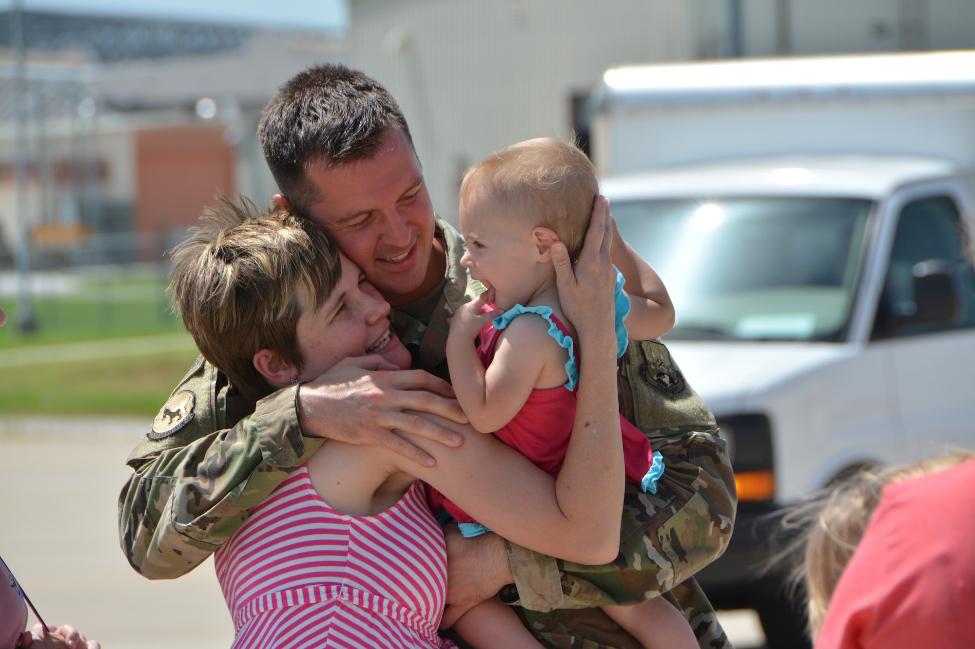 Staff Sgt. Noah Garris, a combat crew communications technician with the 507th Operations Support Squadron at Tinker Air Force Base, Okla., embraces his family following a deployment July 3, 2018. More than 100 Reserve Citizen Airmen from the 507th Air Refueling Wing at Tinker AFB deployed to Incirlik Air Base, Turkey, in support of air operations. (U.S. Air Force photo by Tech. Sgt. Samantha Mathison)