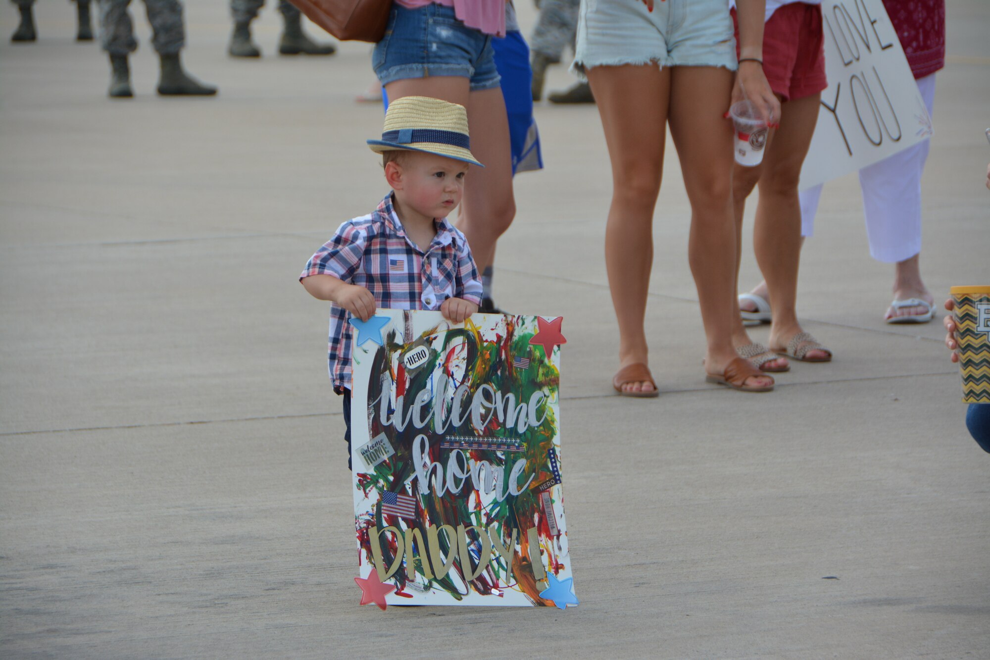 A child holds a welcome home sign made for his father July 5, 2018, at Tinker Air Force Base, Okla. More than 100 Reserve Citizen Airmen from the 507th Air Refueling Wing at Tinker AFB deployed to Incirlik Air Base, Turkey, in support of air operations. (U.S. Air Force photo by Tech. Sgt. Samantha Mathison)
